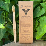 Showcase Rowe Naturals' eco-friendly bamboo and boar bristle toothbrush, highlighting its biodegradable packaging and commitment to plastic-free oral hygiene.