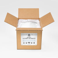 A box of Rustic Strength unscented, hypoallergenic powder laundry detergent, promising 160 loads, sits open revealing the white powder inside.