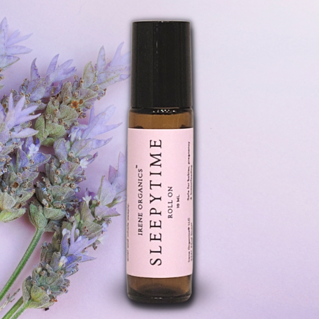 Irene Organics' Sleepytime aromatherapy roll-on is displayed next to a sprig of fresh lavender.
