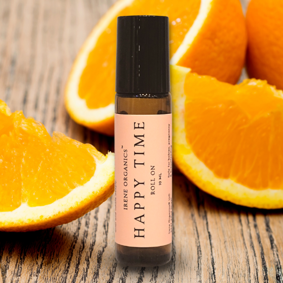 Aromatherapy product, Irene Organics Happy Time essential oil roller, sits amongst vibrant orange slices on a wooden surface.
