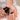 Person pours brown supplement capsules from a bottle into their hand.
