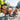 Two children playing by a river with trees in the background