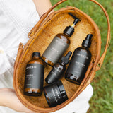 Basket with skincare products labeled 'Grace + Rae' held by a person outdoors.