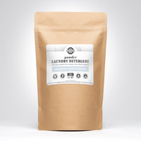 A kraft paper bag presents Rustic Strength powder laundry detergent, advertising unscented, hypoallergenic, and earth-derived minerals.
