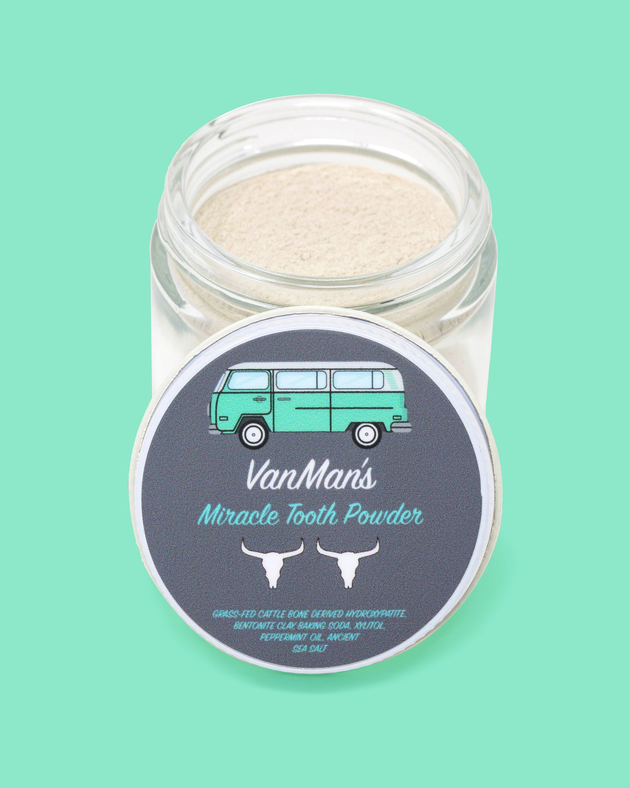 View shows VanMan's Miracle Tooth Powder in an open jar, featuring a retro van illustration.
