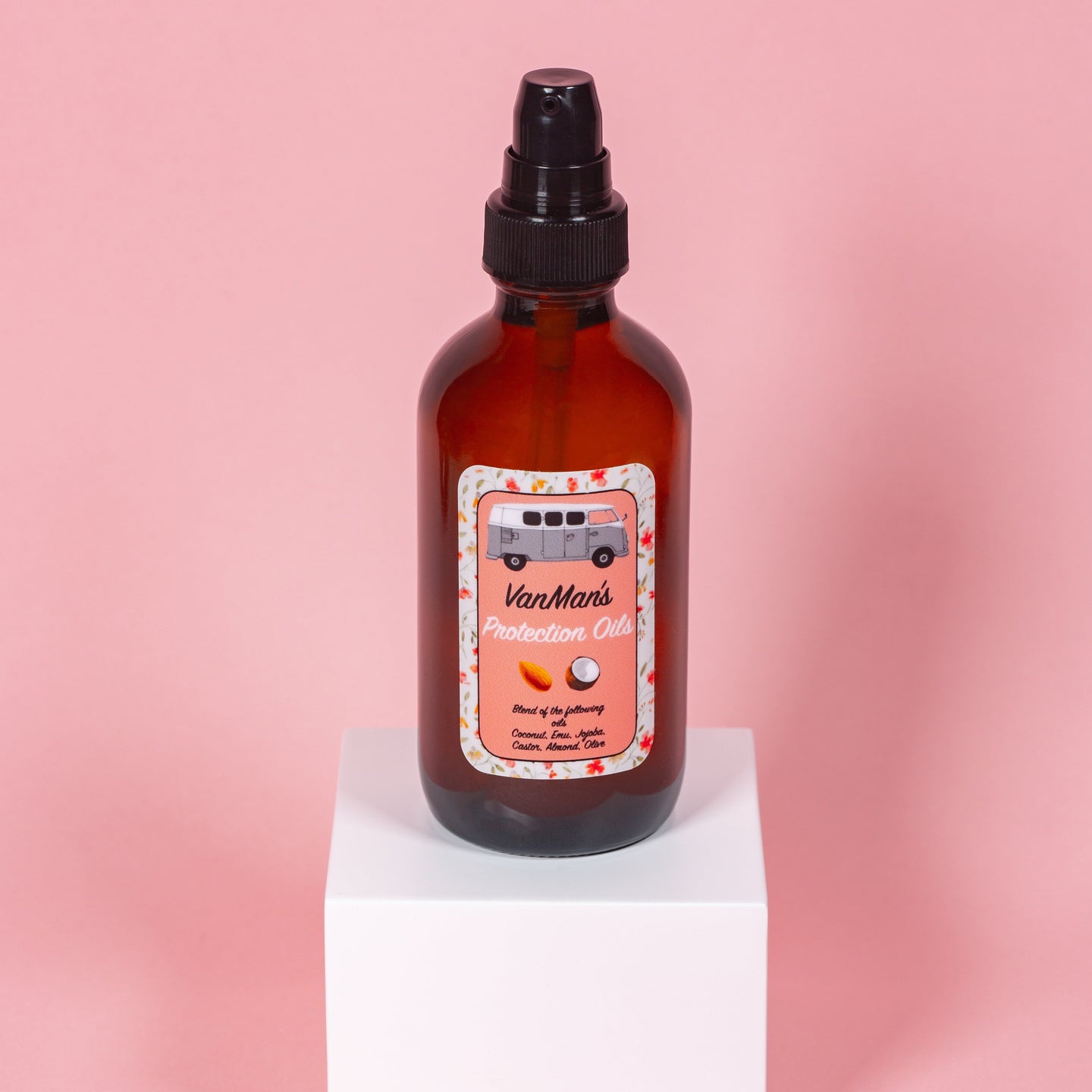 VanMan's Protection Oils bottle with coconut, almond, and olive blend sits on a white cube.
