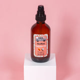 VanMan's Protection Oils bottle with coconut, almond, and olive blend sits on a white cube.

