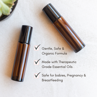 Two amber glass roller bottles containing organic essential oils offer a gentle and safe formula for babies, pregnancy, and breastfeeding.
