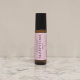 Irene Organics Sleepytime roll-on sits on a marble surface.
