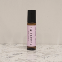 Irene Organics Sleepytime roll-on sits on a marble surface.
