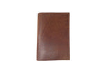 A brown leather wallet stands vertically against a white background, showcasing its sleek, minimalist design.
