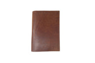 A brown leather wallet stands vertically against a white background, showcasing its sleek, minimalist design.

