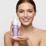 A smiling woman presents Taylor Made face cleanser designed for acne-prone skin.
