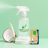 Green Llama all-purpose cleaner sprays mist near coconut on a light green background, featuring a fragrance-free refill packet.
