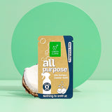 Green Llama presents its all-purpose, fragrance-free cleaner refill packet next to a halved coconut.
