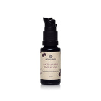 Annmarie Anti-Aging Facial Oil sits upright in a small black bottle with a pump dispenser.
