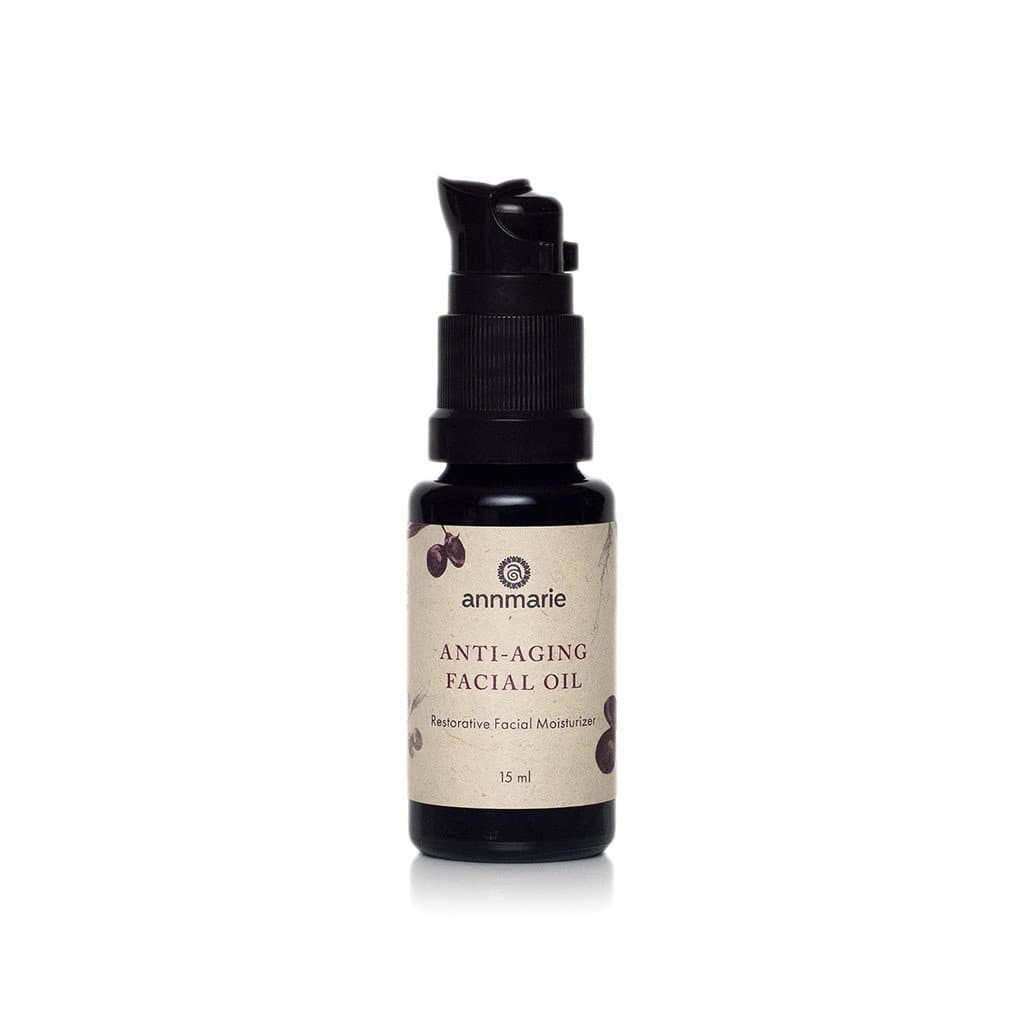 Annmarie Anti-Aging Facial Oil sits upright in a small black bottle with a pump dispenser.
