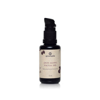 Annmarie Anti-Aging Facial Oil sits on a white surface, showcasing its restorative moisturizer qualities.
