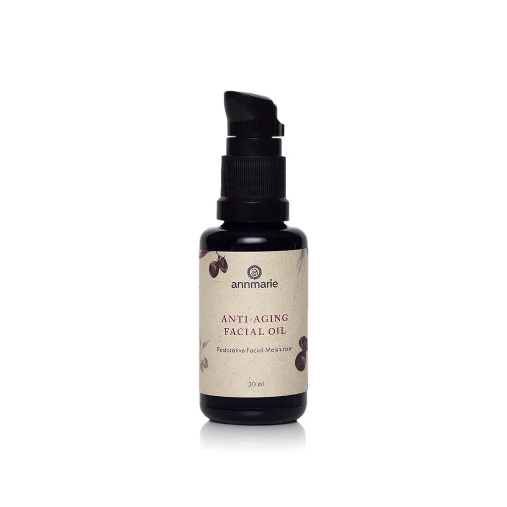 Annmarie Anti-Aging Facial Oil sits on a white surface, showcasing its restorative moisturizer qualities.
