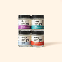 Display features Bloop laundry soap jars in Stone Fruit, Salt Air, Care Free, and Super Bloom scents.
