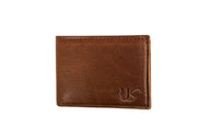A brown leather wallet displays a subtle "US" logo.
