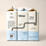 Three bloop laundry soap cartons feature modern design, touting natural ingredients and inviting scents.
