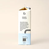 A carton of HeyBloop elevated laundry soap promotes its natural ingredients and scents, inviting customers to learn more via a QR code.