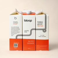 Three Bloop laundry soap cartons, featuring passionfruit and vanilla orchid scents, promise a pleasant, eco-friendly laundry experience.
