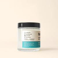 Close-up shows a jar of Bloom Laundry Soap in Salt Air scent, highlighting its eco-friendly, toxin-free ingredients.
