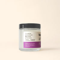 Bloom laundry soap in a glass jar advertises its cruelty-free, toxin-free, and earth-friendly ingredients.
