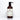 A brown bottle of Rustic Strength body wash, labeled unscented and hypoallergenic, sits against a white marble tile background.

