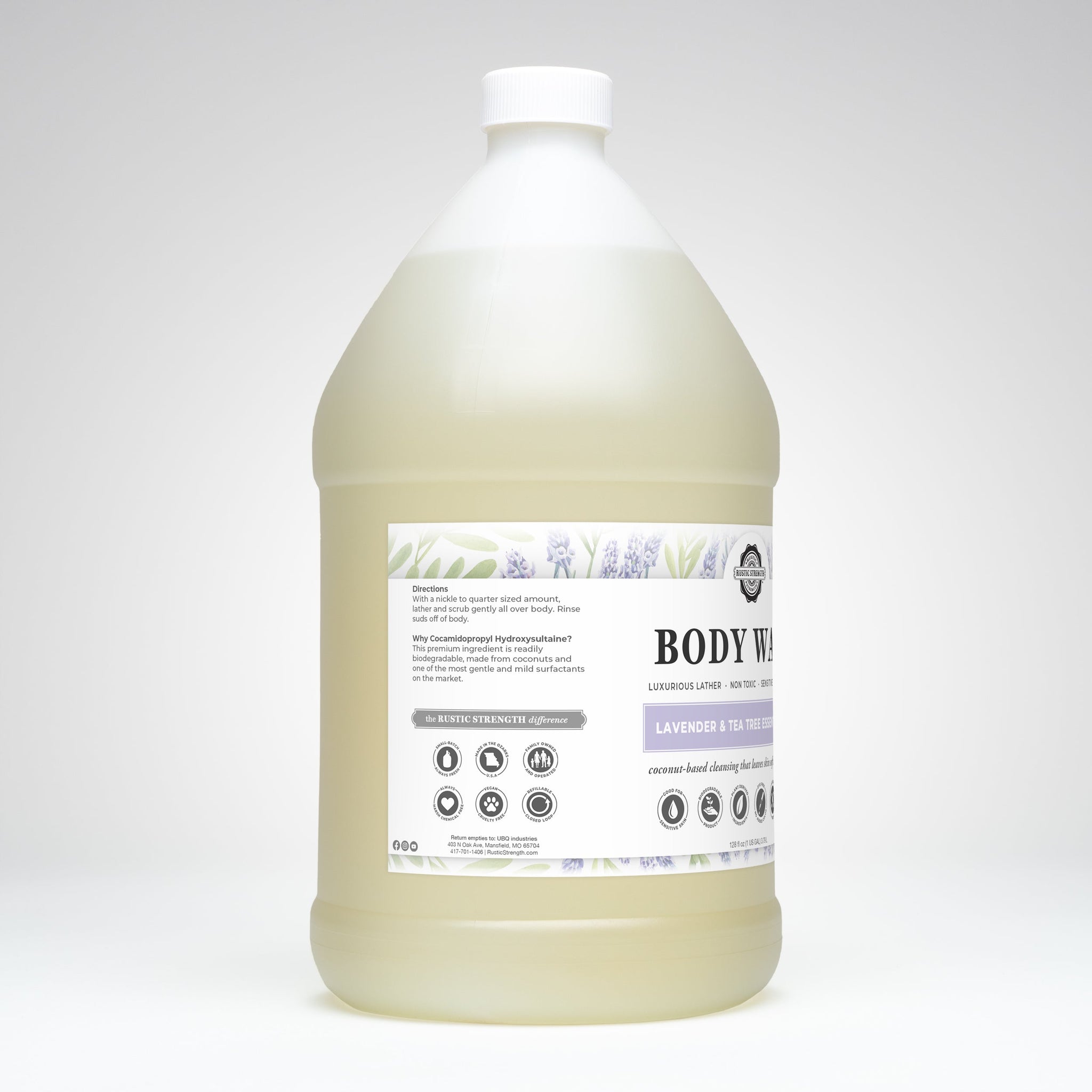 Rustic Strength displays a large gallon jug of their lavender and tea tree essential oil body wash, emphasizing its natural, coconut-based cleansing formula.

