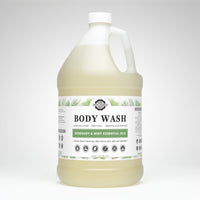 A gallon jug displays Rustic Strength body wash, touting rosemary and mint essential oils for luxurious lather and sensitive skin.
