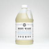 A large bottle of Rustic Strength Body Wash advertises its unscented, hypoallergenic, and coconut-based formula for sensitive skin.