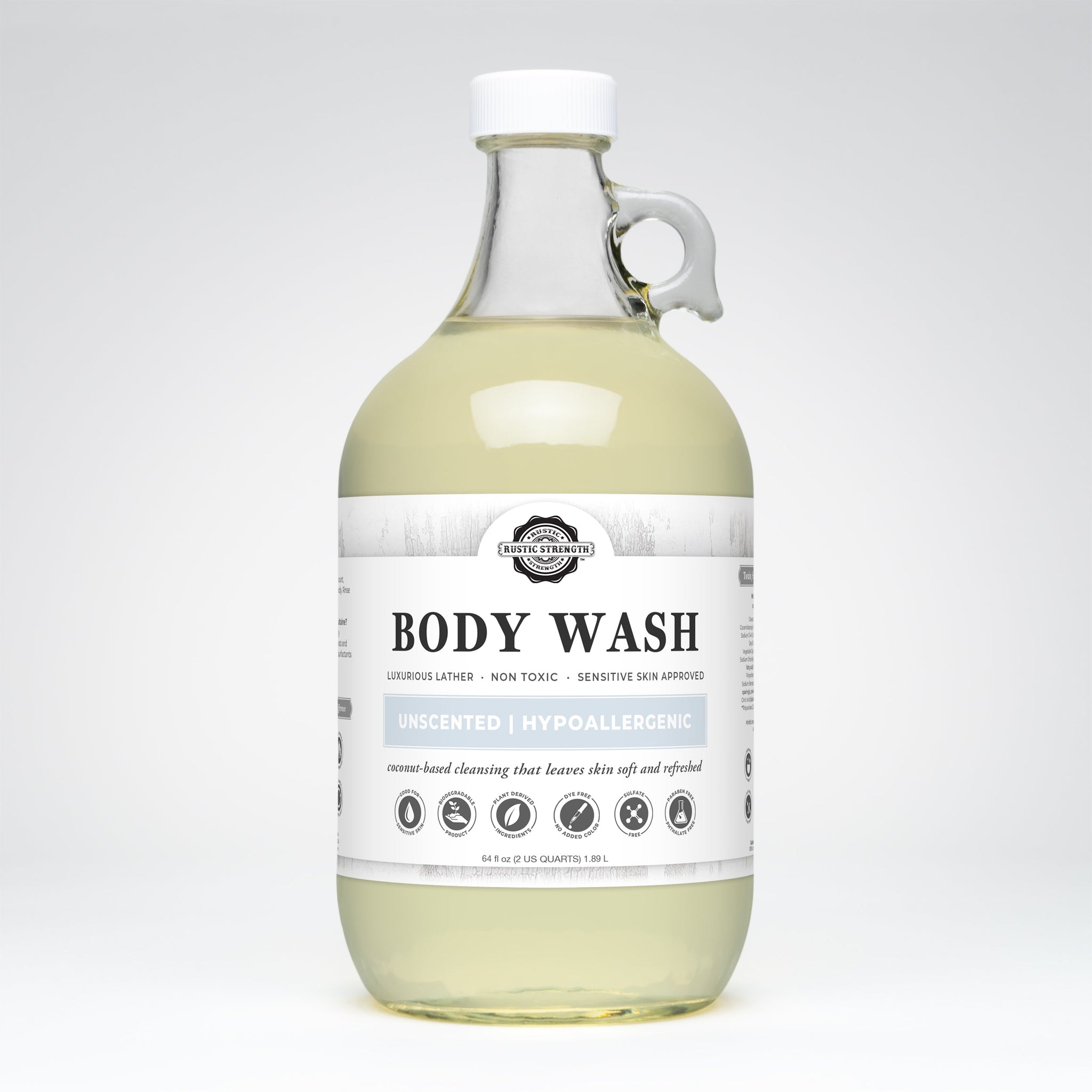 Rustic Strength's unscented body wash, a coconut-based cleanser in a clear glass jug, promises luxurious lather and is suitable for sensitive skin.
