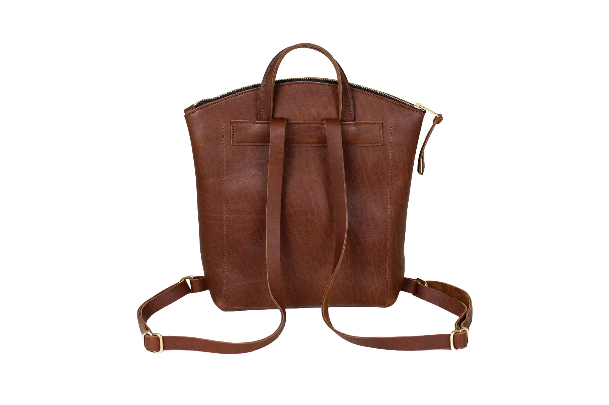 A brown leather backpack displays its adjustable straps, top handle, and zipped closure against a white background.
