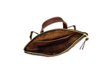 Open brown leather tote bag reveals its suede-lined interior pockets and zipper closure.