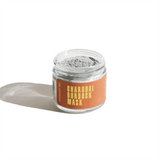 Jar displays Urb Apothecary Charcoal Burdock Mask with a gray powder inside.
