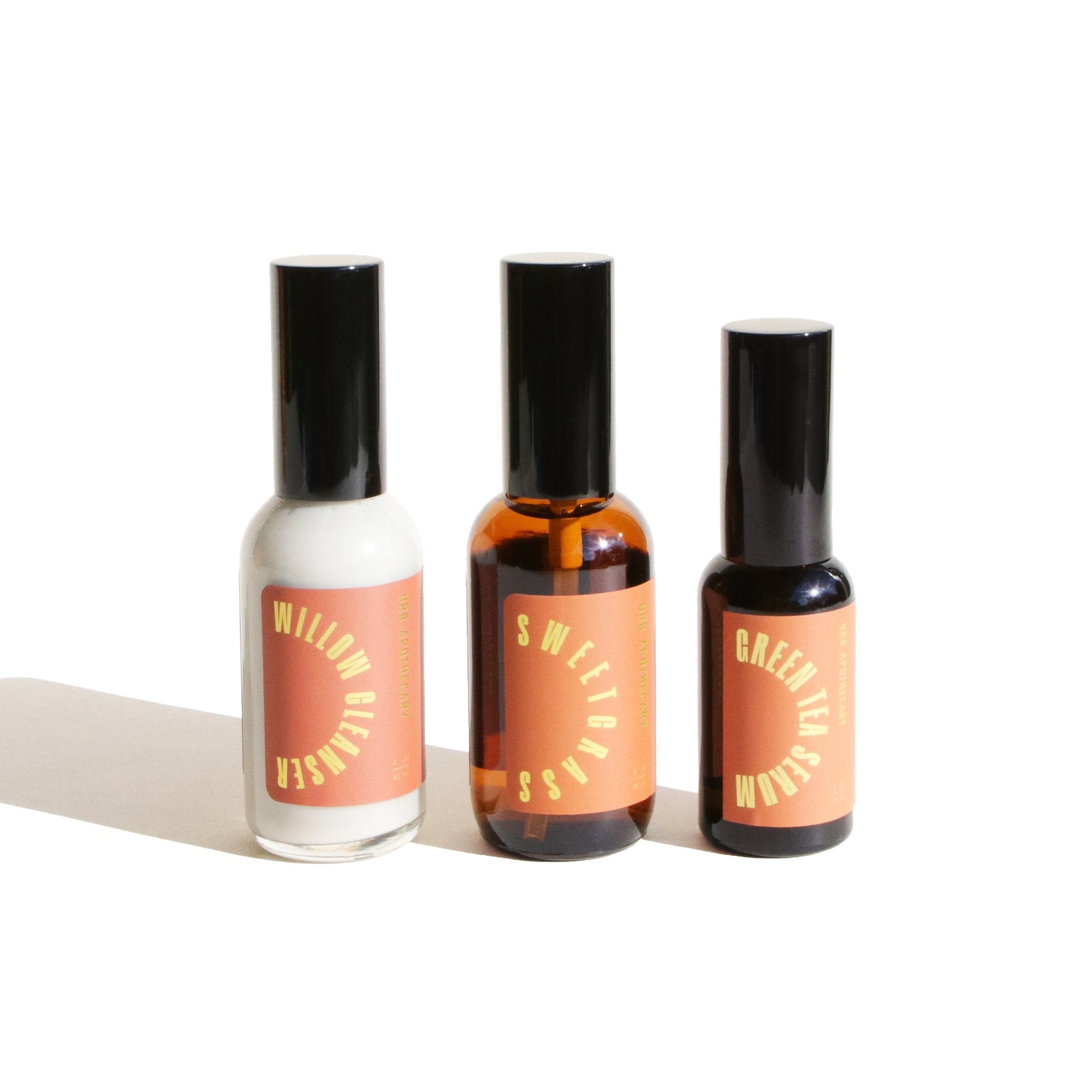 Three bottles showcase UBB Apothecary's Willow Cleanser, Sweetgrass, and Green Tea Serum skincare products.
