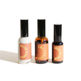 Three apothecary bottles display natural skincare products: willow cleanser, sweetgrass serum, and green tea serum.
