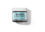 Examine a jar of Wonder Fresh Mint Tooth Powder for natural teeth cleaning and a healthy, eco-friendly dental routine.