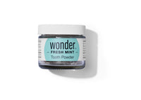 Examine a jar of Wonder Fresh Mint Tooth Powder for natural teeth cleaning and a healthy, eco-friendly dental routine.