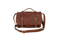 Showcases a stylish brown leather satchel featuring gold buckles and a crossbody strap against a white background.
