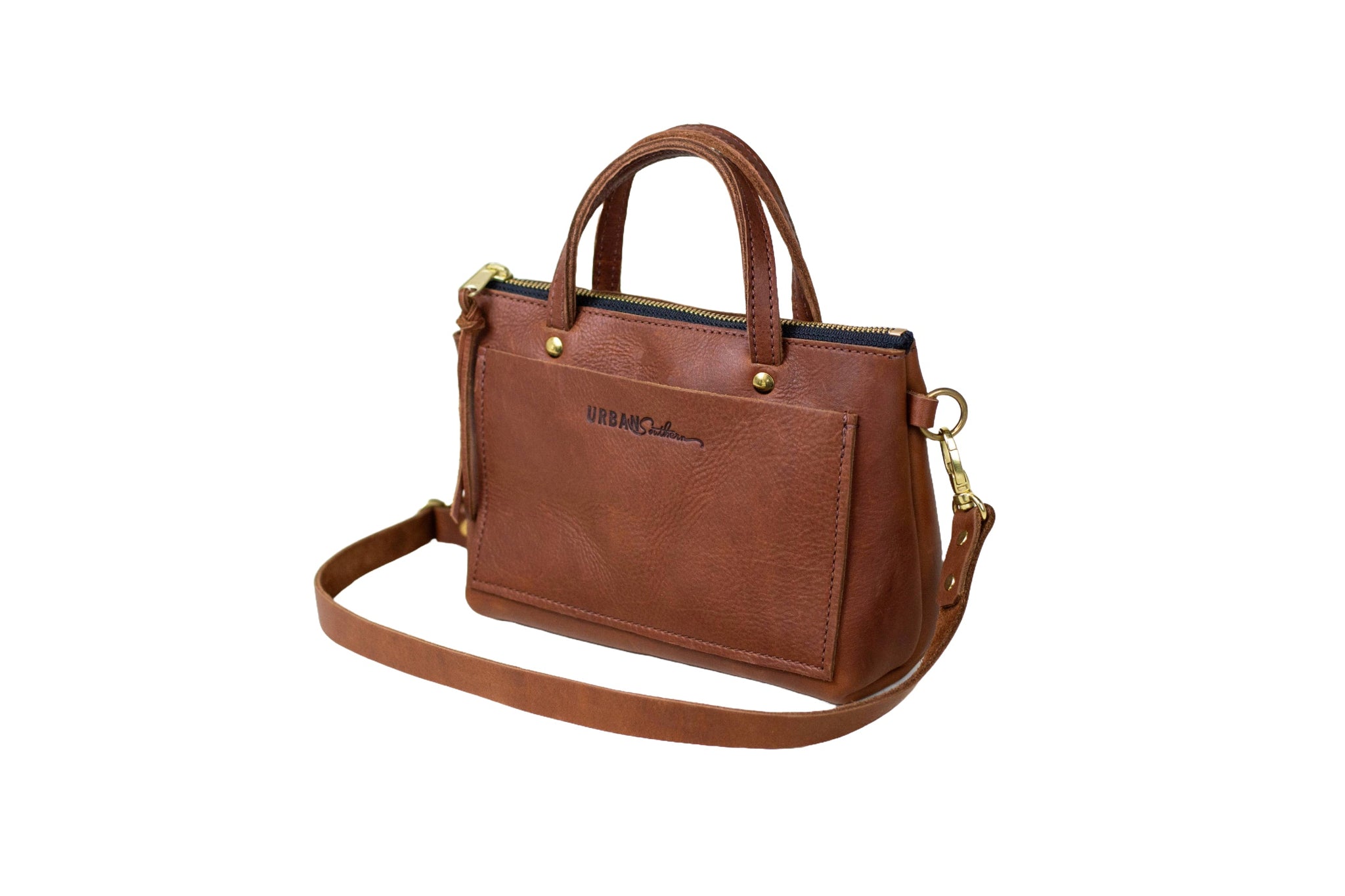 A brown leather Urban Southern handbag with a shoulder strap sits against a white background.
