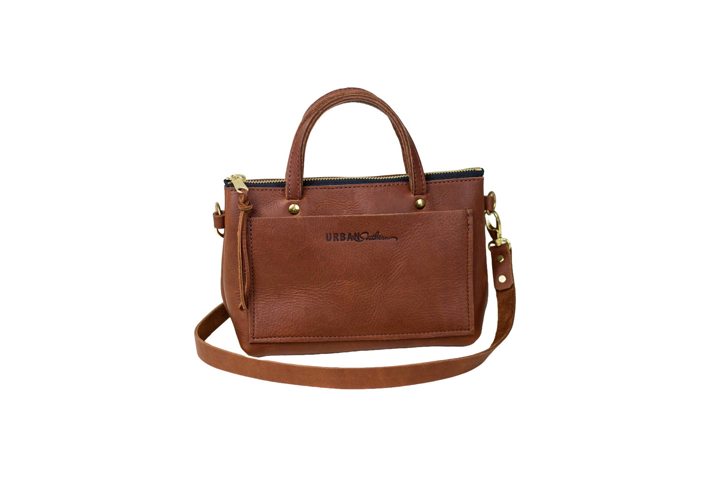 A brown leather Urban Southern handbag features a top handle and a detachable shoulder strap.
