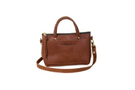 A brown leather Urban Southern handbag features a top handle and a detachable shoulder strap.
