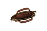 View shows the inside of a brown leather satchel handbag, its zipper open.
