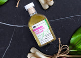 Bottle of ramp wine vinegar with a label on a dark surface with ramps.