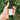 Hand holds a bottle of Annmarie Citrus Mint Cleanser, an herb-infused facial gel cleanser, against a blurred green foliage background.
