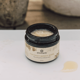 Annmarie Coconut Honey Mask sits open on a white surface with a dollop of product beside it.

